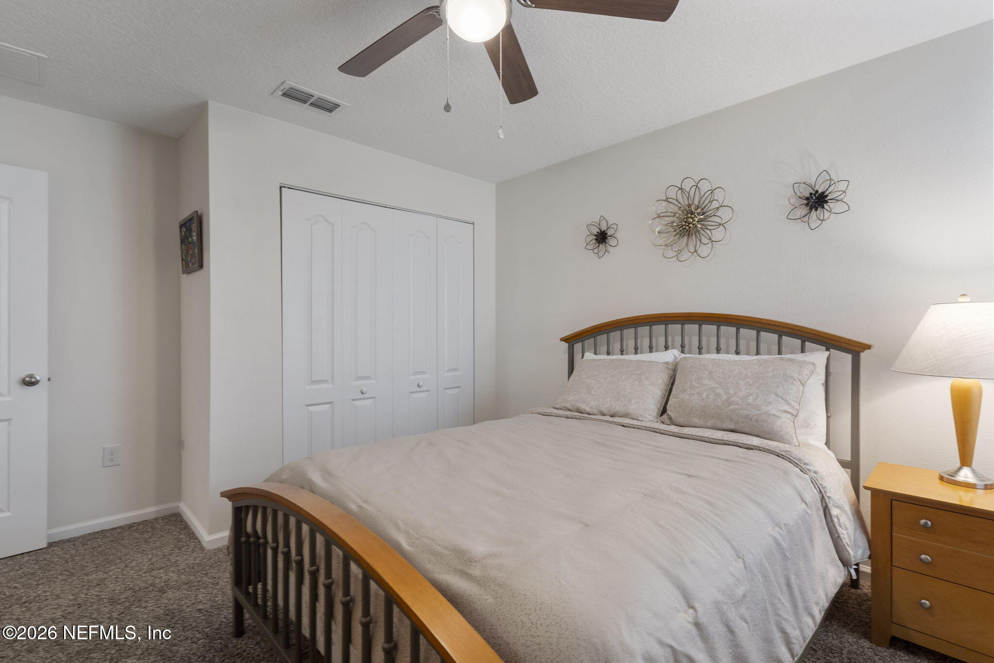 65 Mula Ct Street St. Augustine, FL 32084 - Photo 28 of 38 a bedroom with a bed and a chandelier