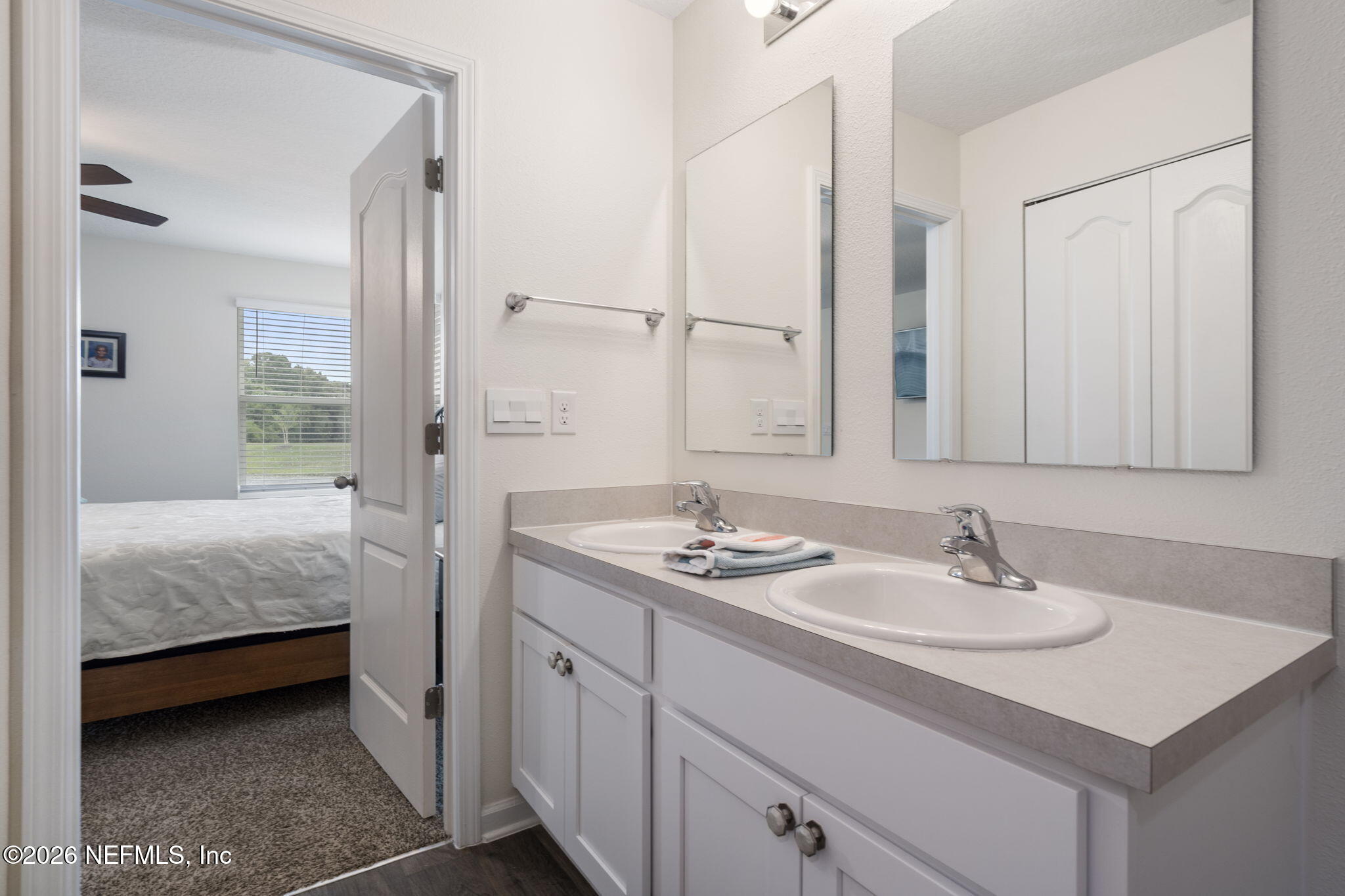 65 Mula Ct Street St. Augustine, FL 32084 - Photo 30 of 38 a en suite bathroom with a double vanity sink a mirror and a