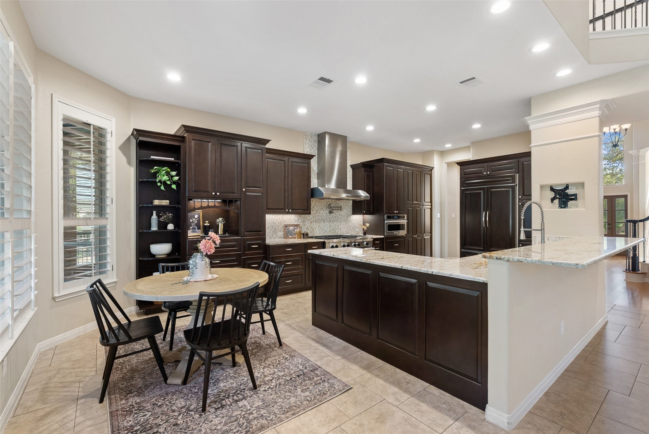 8215 Dark Ridge Cove Austin, TX 78737 - Photo 13 of 40 Culinary aspirations come alive in this kitchen, boasting premium appliances, upgraded cabinets, granite countertops, and ample space for entertaining.