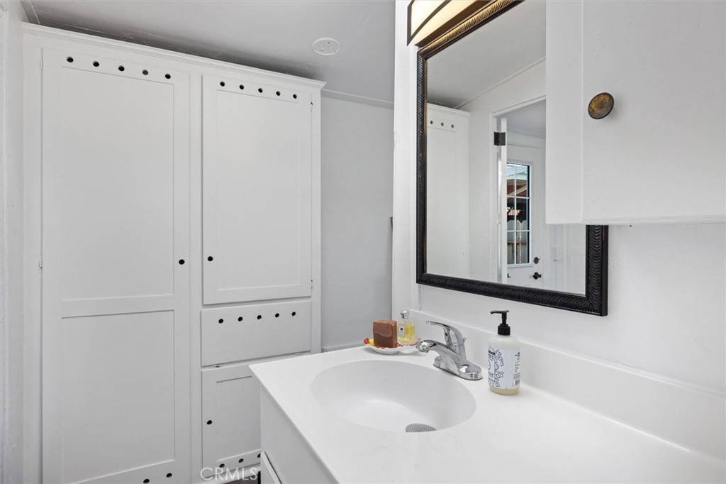 331 Panay Street Morro Bay, CA 93442 - Photo 14 of 29 a bathroom with a sink and a mirror