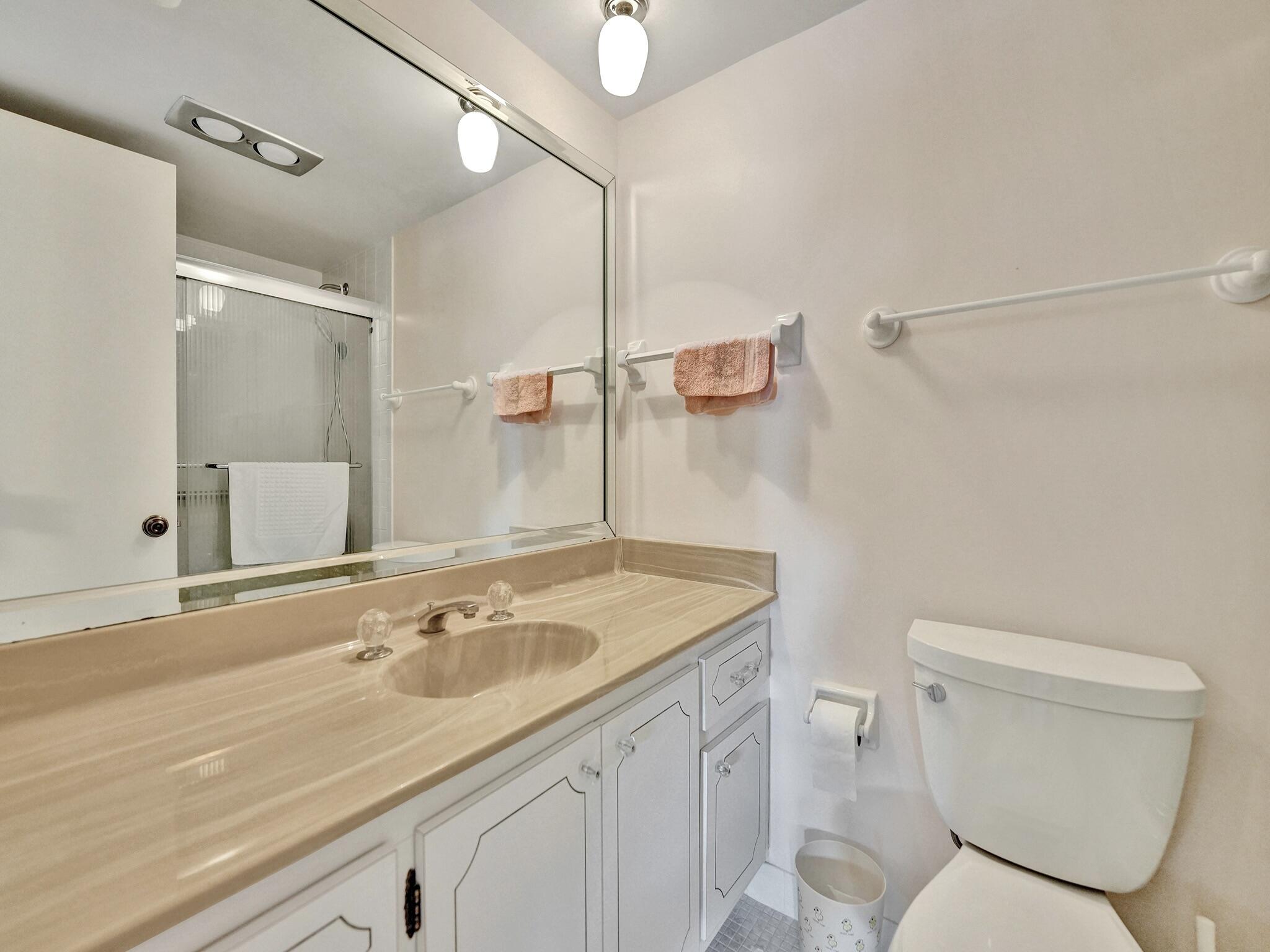 3300 South Ocean Boulevard, Unit 1021C Highland Beach, FL 33487 - Photo 13 of 45 a bathroom with a sink toilet vanity and shower