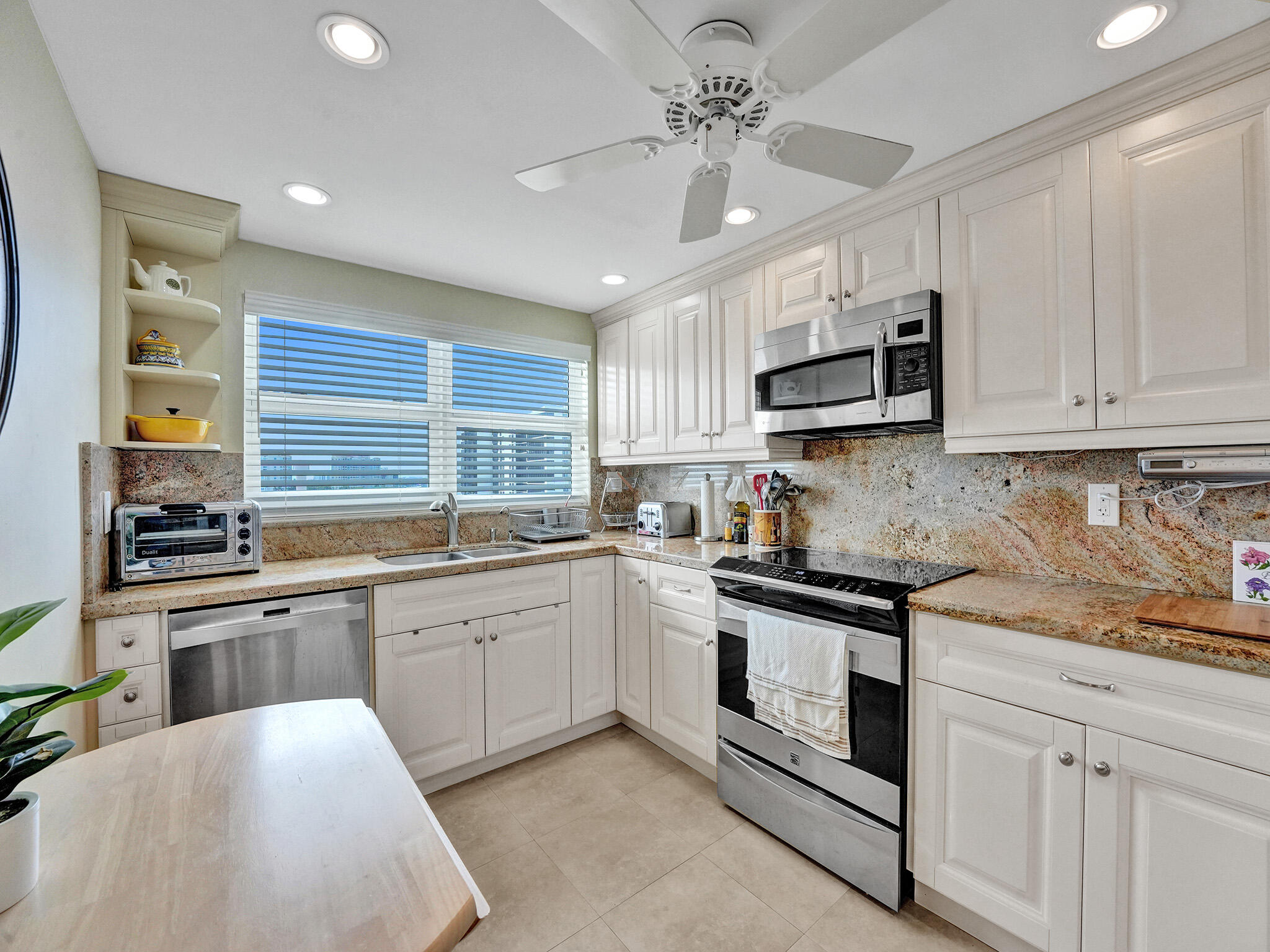 3300 South Ocean Boulevard, Unit 1021C Highland Beach, FL 33487 - Photo 2 of 45 a kitchen with stainless steel appliances granite countertop a stove and cabinets