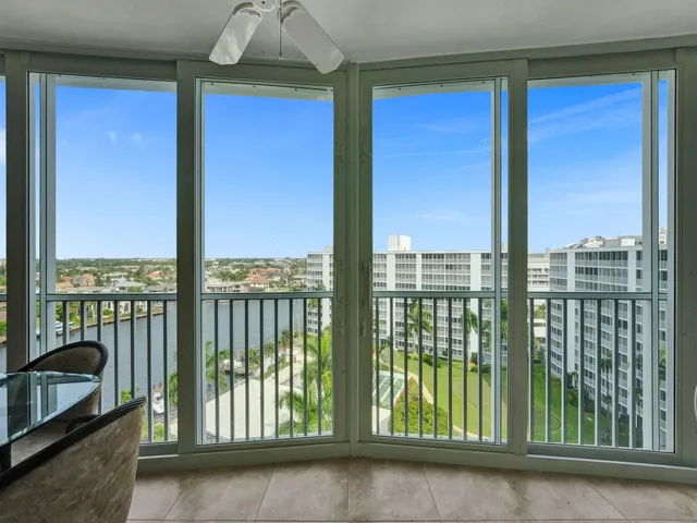 a balcony with furniture and a ceiling fan