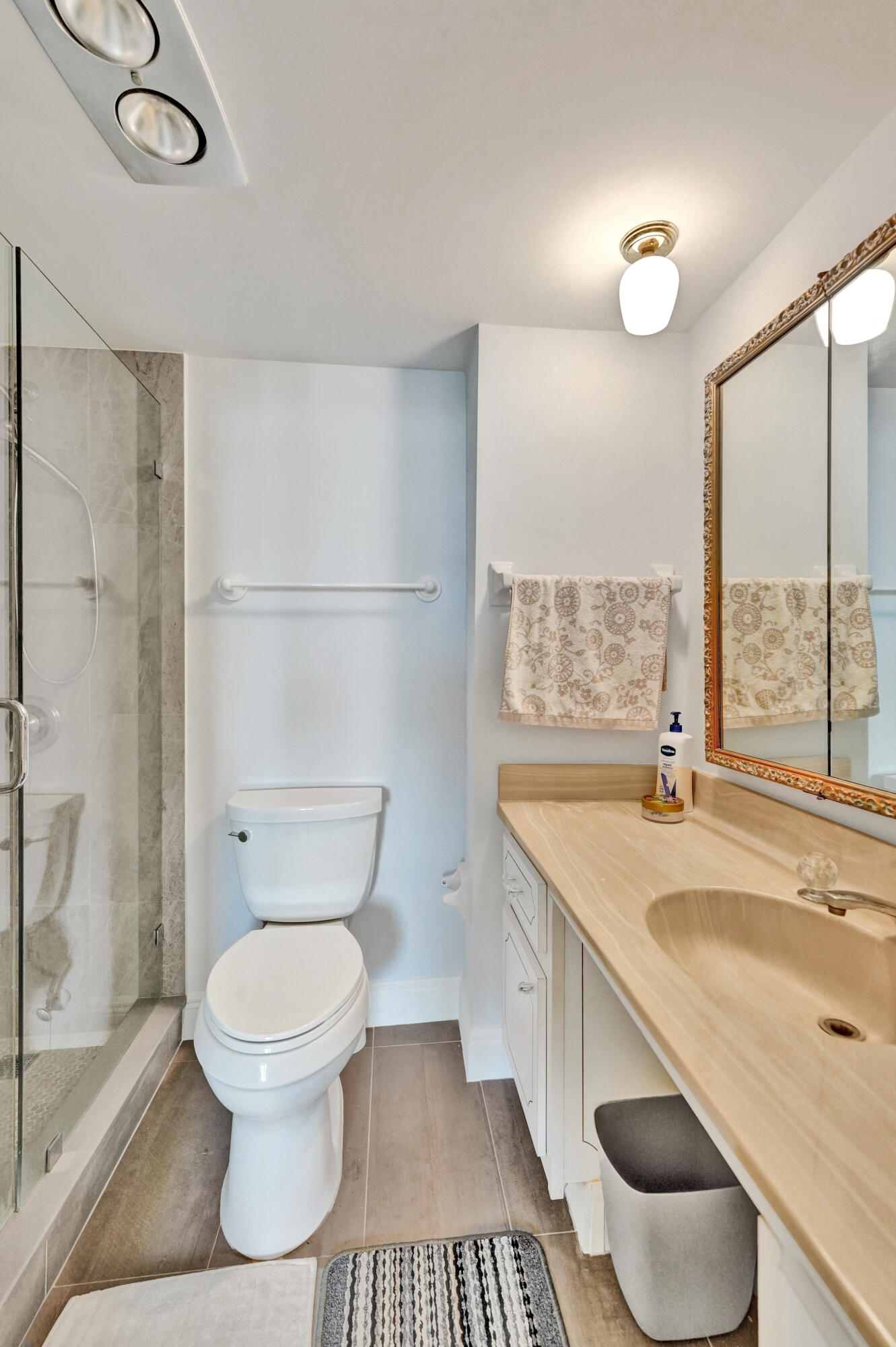 3300 South Ocean Boulevard, Unit 1021C Highland Beach, FL 33487 - Photo 25 of 45 a white toilet sitting next to a bathroom sink