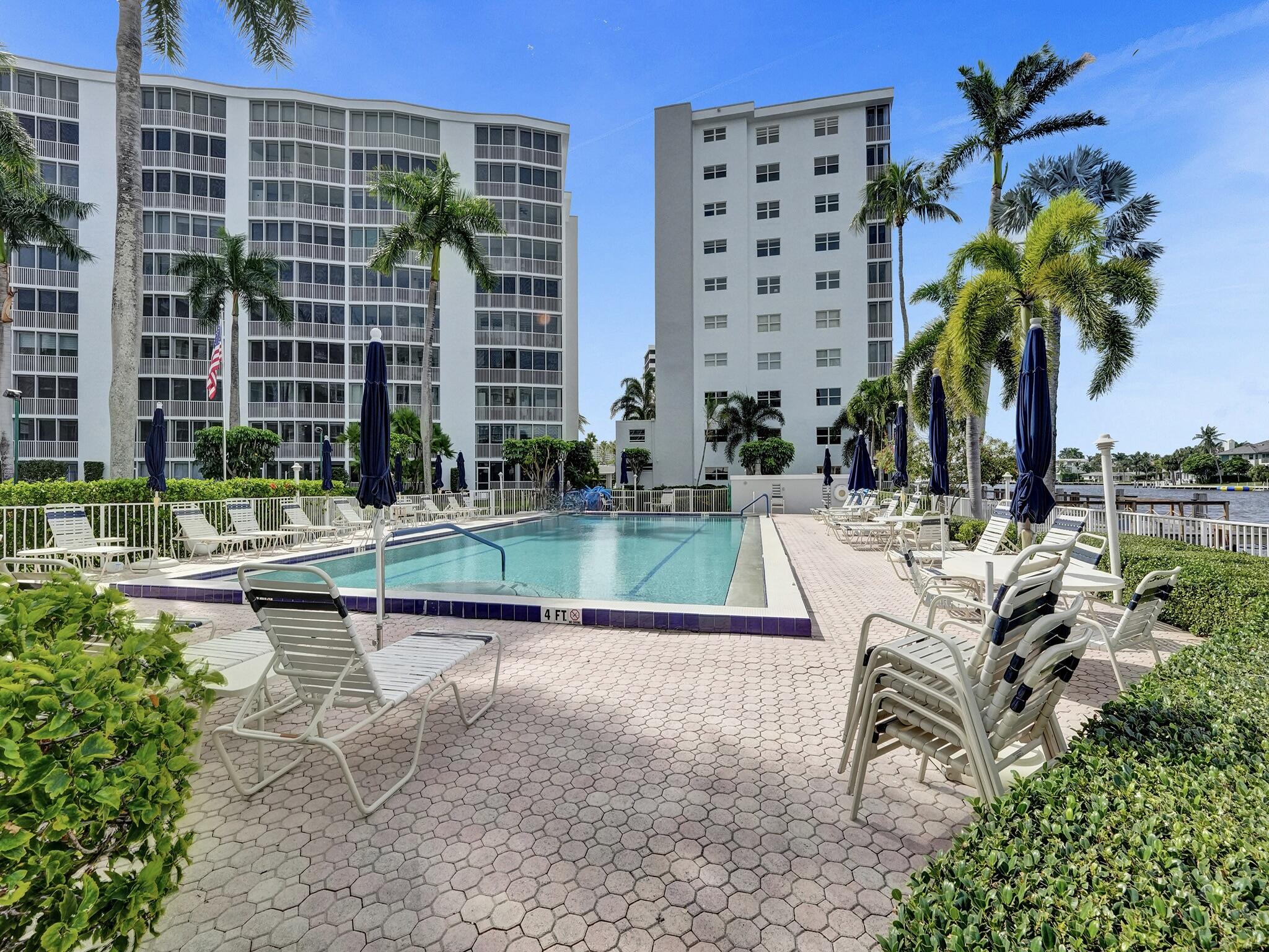 3300 South Ocean Boulevard, Unit 1021C Highland Beach, FL 33487 - Photo 31 of 45 a view of a swimming pool with a lounge chairs