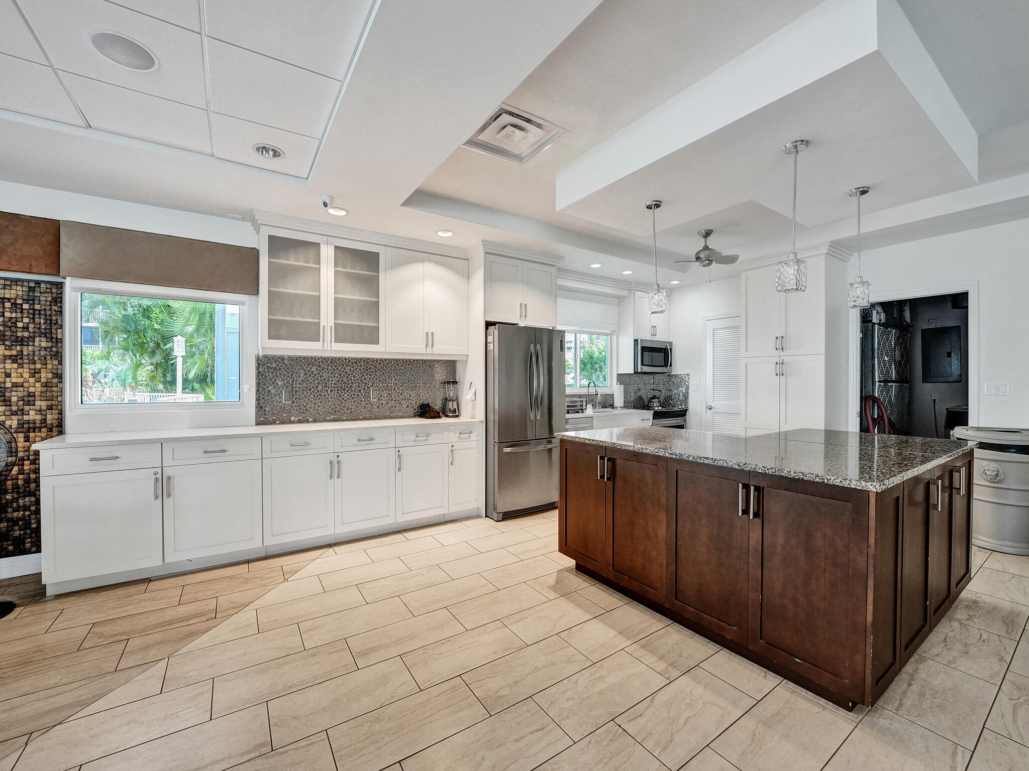 3300 South Ocean Boulevard, Unit 1021C Highland Beach, FL 33487 - Photo 38 of 45 a large kitchen with kitchen island granite countertop lots of counter top space and stainless steel appliances