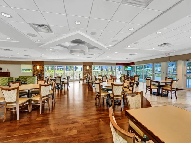 a dining room with furniture and a floor to ceiling window