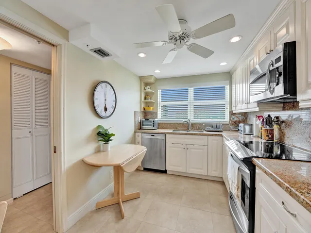 a kitchen with a sink cabinets and window
