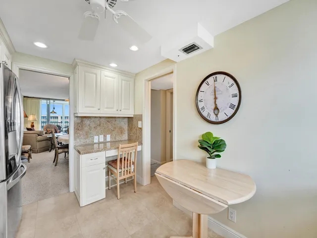 a living room with a clock and a chandelier