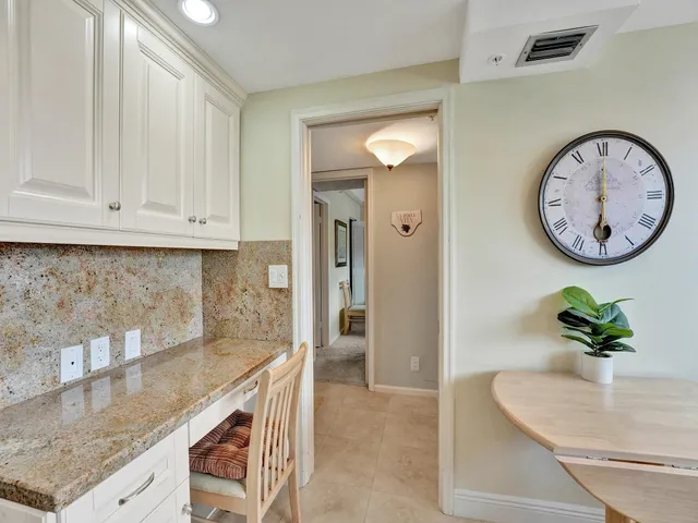 a kitchen with stainless steel appliances granite countertop a sink a stove and cabinets
