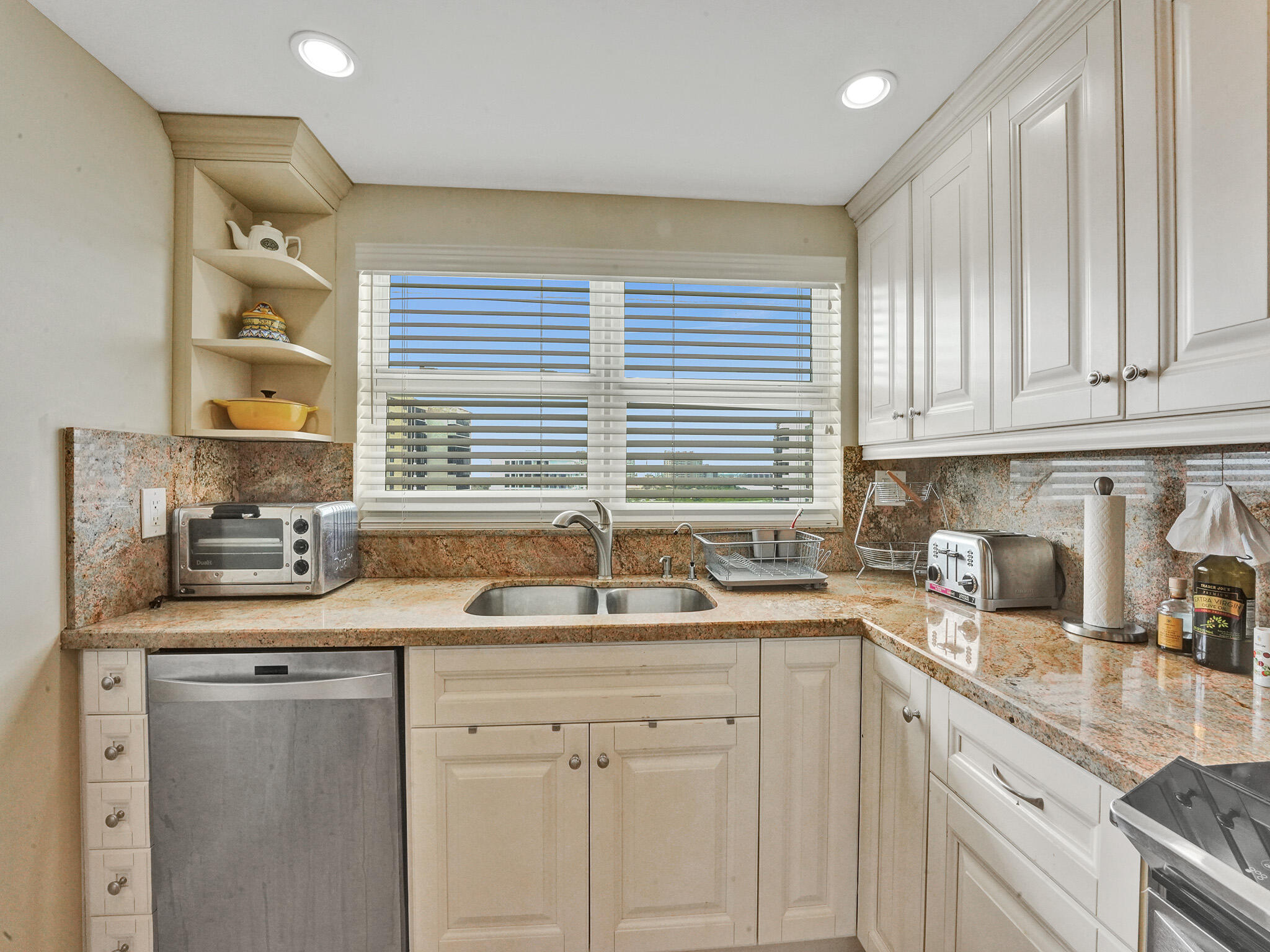 3300 South Ocean Boulevard, Unit 1021C Highland Beach, FL 33487 - Photo 8 of 45 a kitchen with stainless steel appliances granite countertop a sink a stove and cabinets