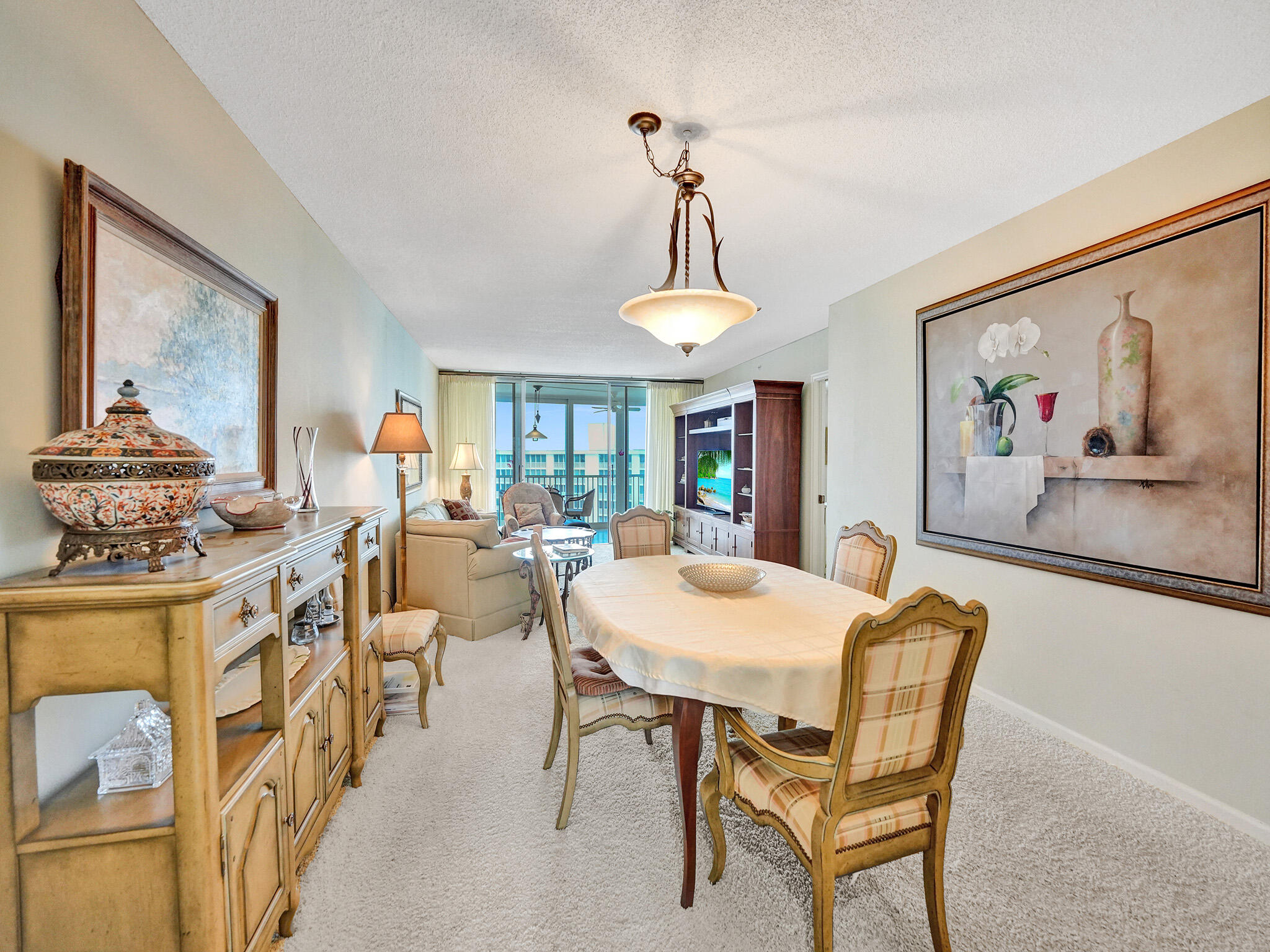 3300 South Ocean Boulevard, Unit 1021C Highland Beach, FL 33487 - Photo 10 of 45 a view of a dining room with furniture and a chandelier