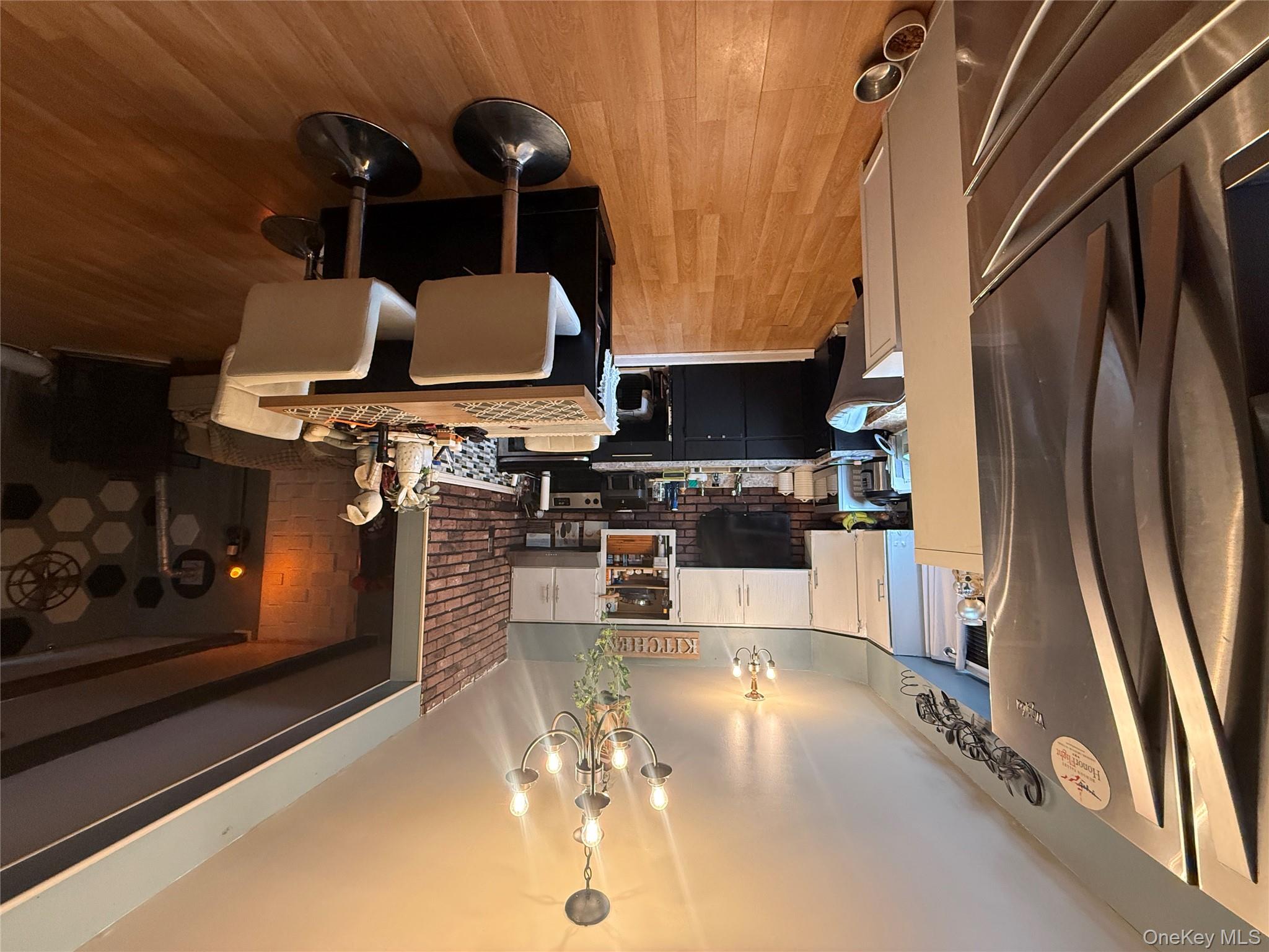 37 Robert Road Kiamesha Lake, NY 12751 - Photo 13 of 25 a large kitchen with a table chairs refrigerator and microwave