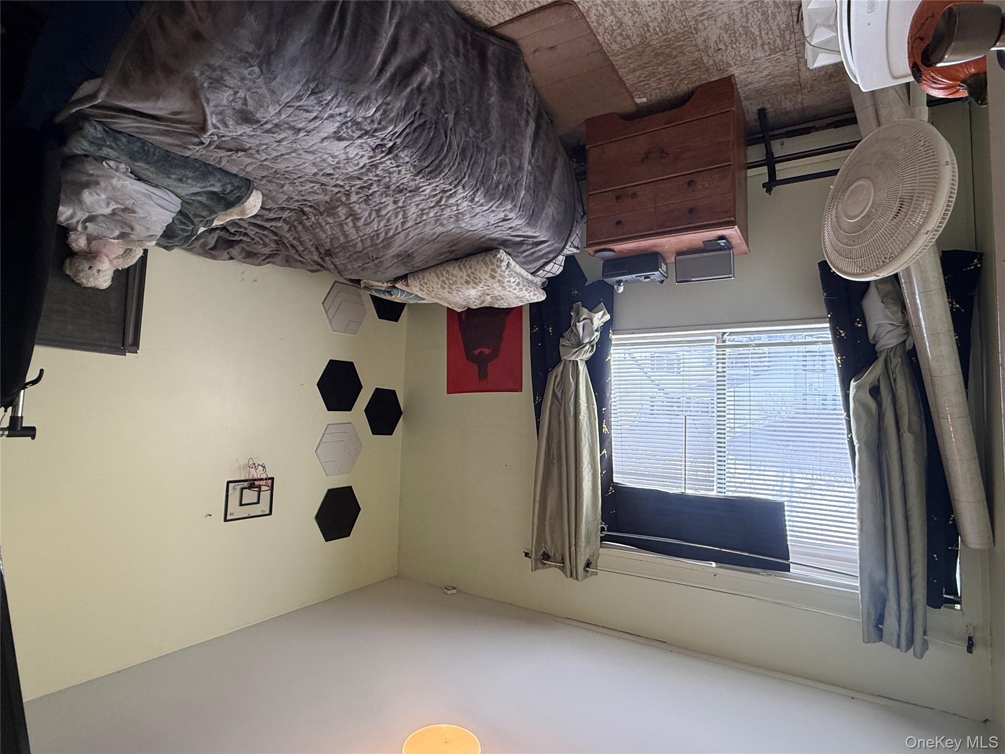 37 Robert Road Kiamesha Lake, NY 12751 - Photo 8 of 25 a bedroom with a bed and a window