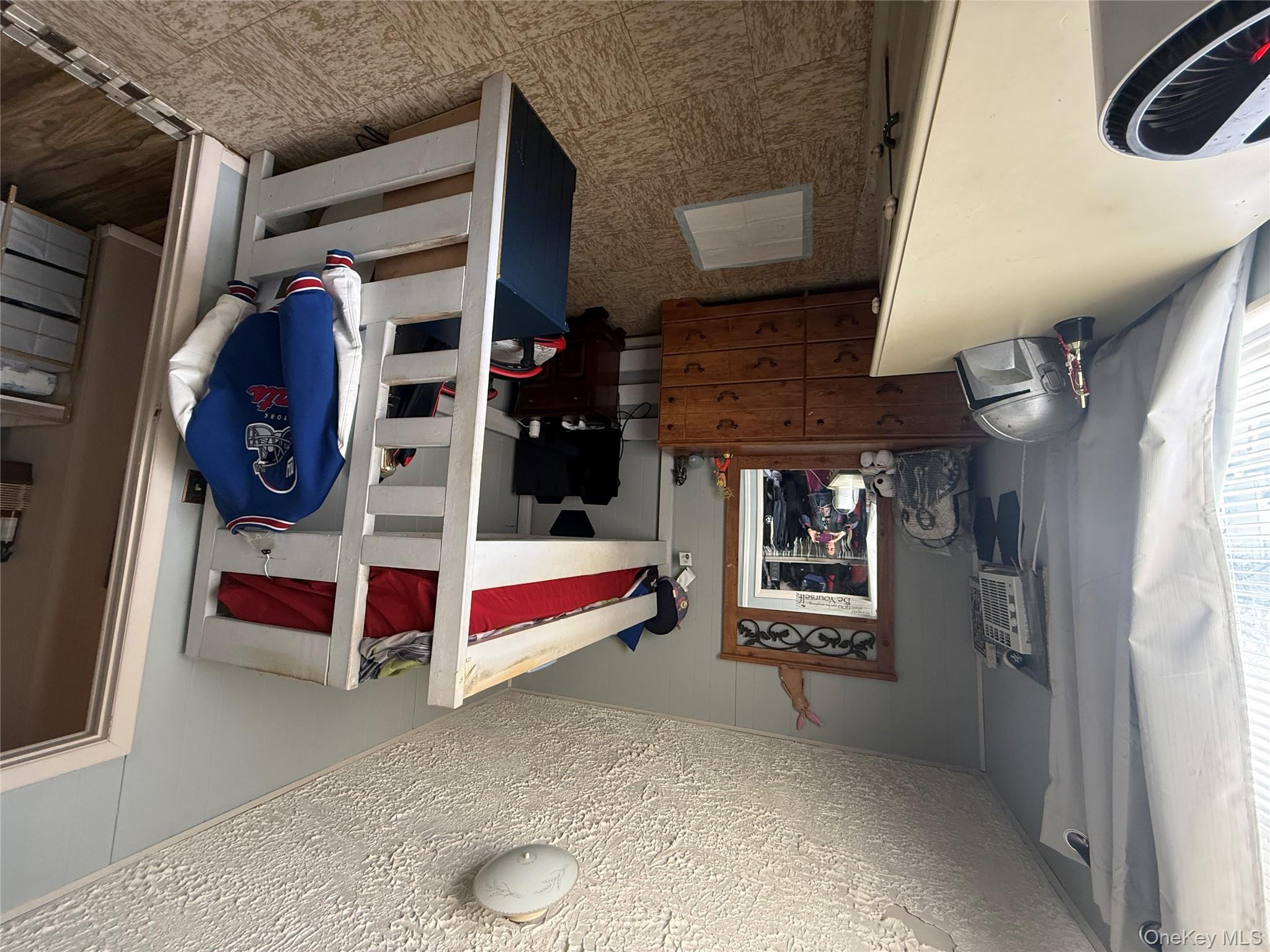 37 Robert Road Kiamesha Lake, NY 12751 - Photo 9 of 25 a bedroom with furniture and a fireplace