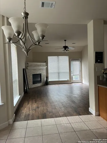 a view of a livingroom with a ceiling fan and window