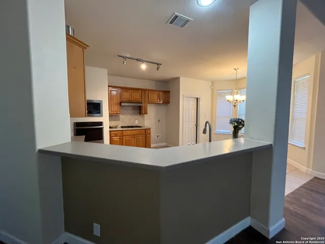 a kitchen with kitchen island a sink appliances and cabinets