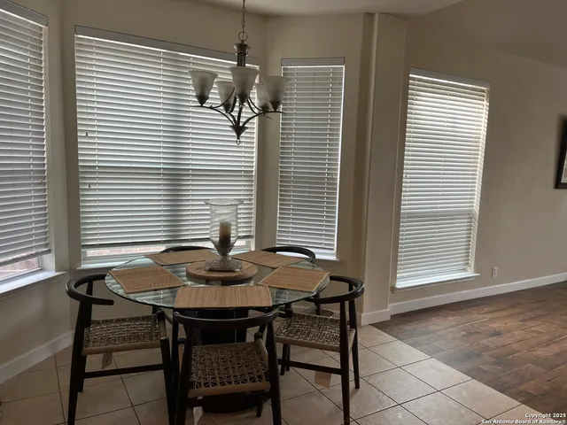 a view of a dining room with furniture and window
