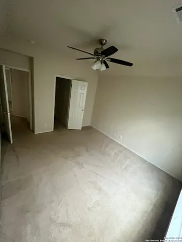 an empty room with a ceiling fan