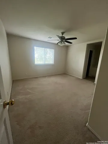 a view of a livingroom with a ceiling fan and window