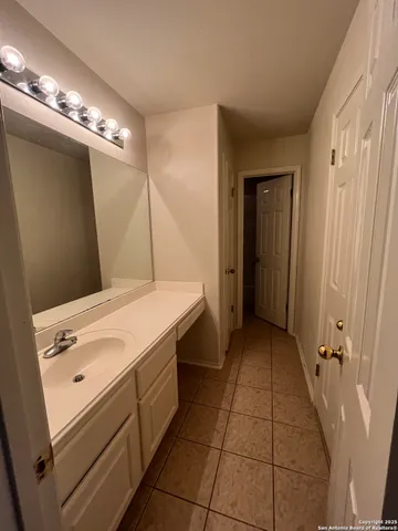 a bathroom with a sink vanity and a mirror