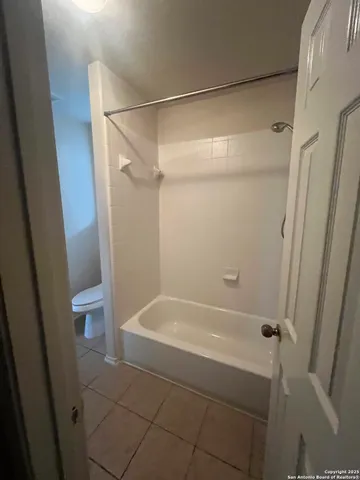 a bathroom with a shower and a toilet