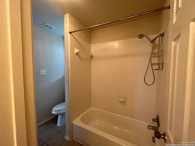 a bathroom with a shower and a toilet