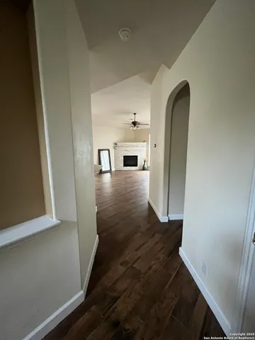 a view of a hallway with wooden floor