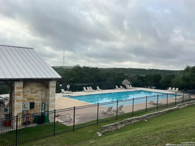 a view of a patio with table and chairs and garden view