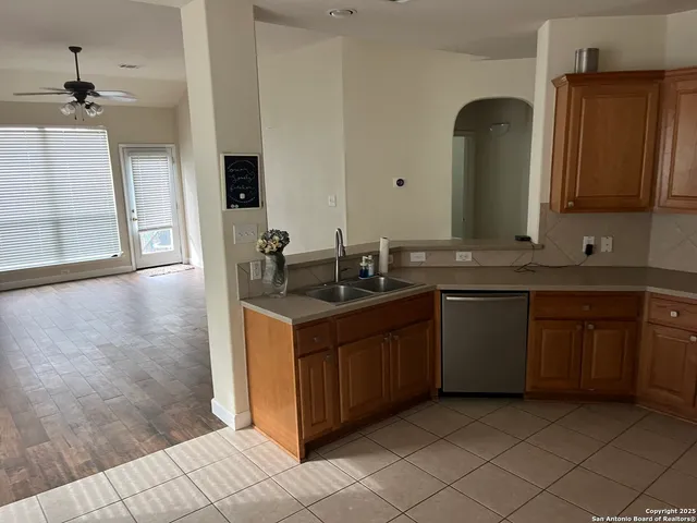 a kitchen with a sink and a mirror