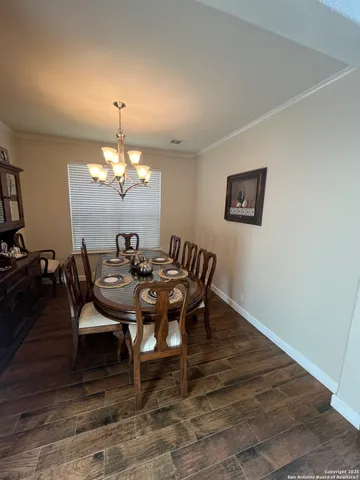 a view of a dining room with furniture and chandelier