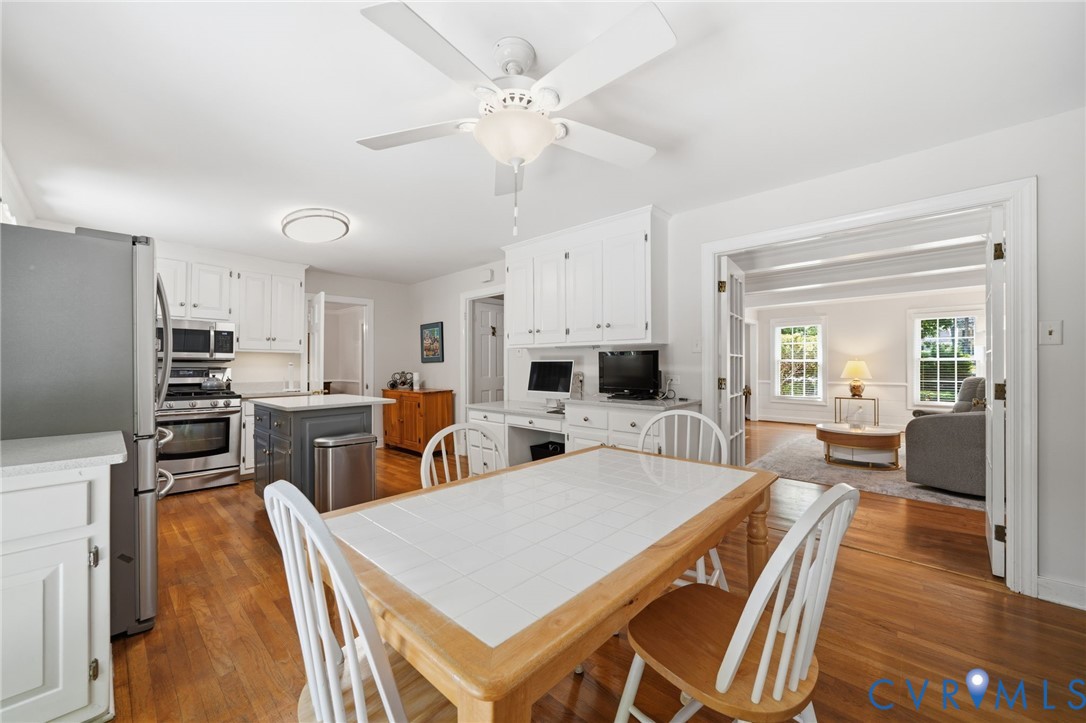 2101 Castlebridge Road Midlothian, VA 23113 - Photo 11 of 37 a large kitchen with cabinets a sink a stove a dining table and chairs