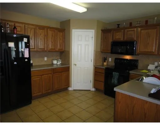 a kitchen with a sink a stove and refrigerator