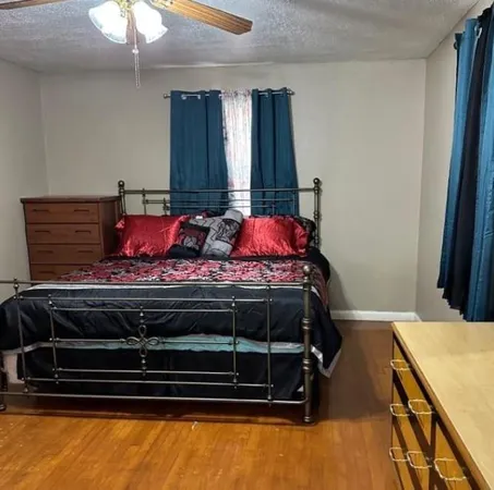 a bedroom with a bed and a chandelier