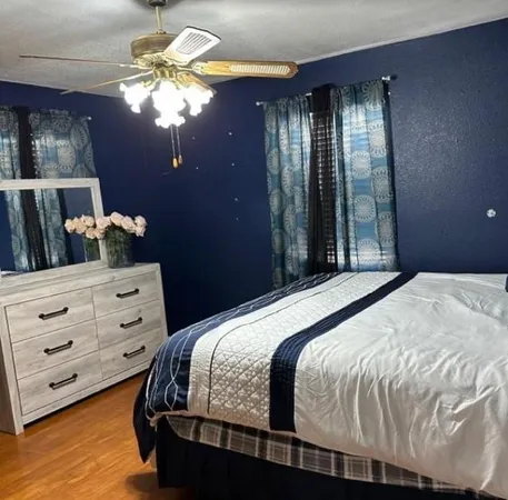 a bedroom with a bed and a chandelier