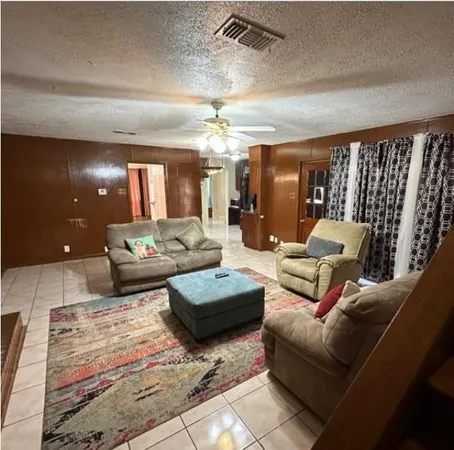 a living room with furniture and chandelier