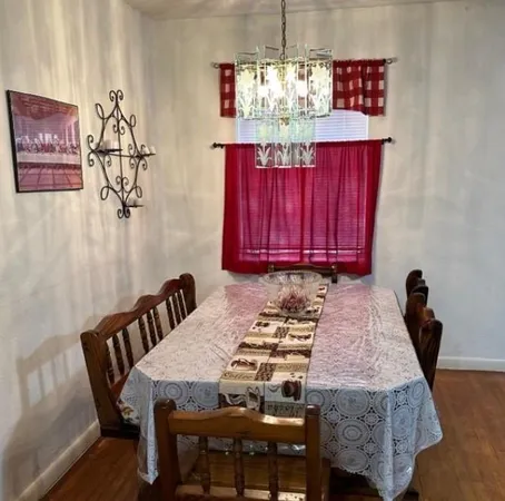 a view of a dining room with furniture and chandelier