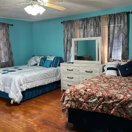 a bedroom with a bed window and a flat screen tv