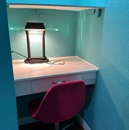 a room with a table chair and wooden floor