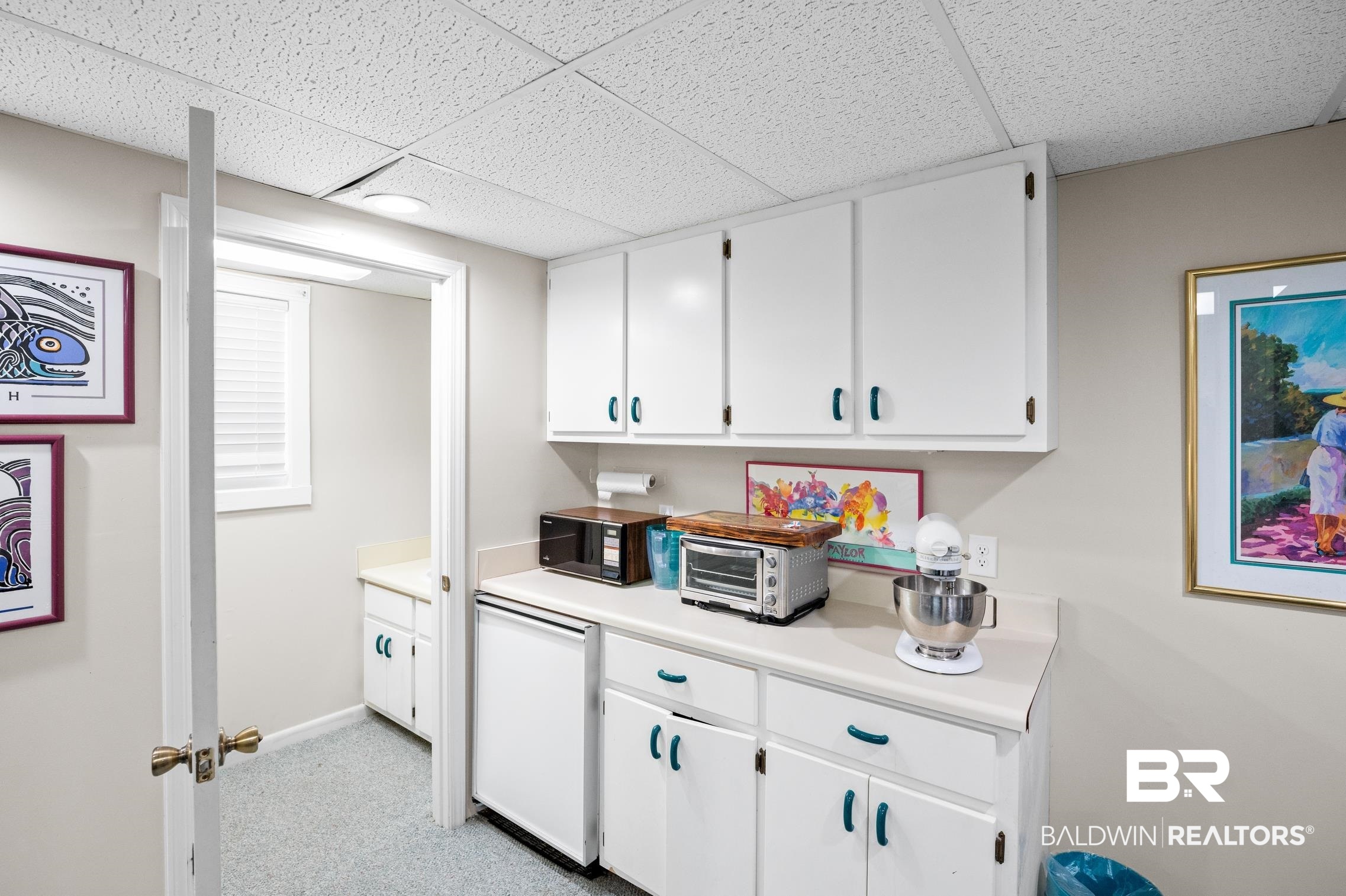 30388 River Road Orange Beach, AL 36561 - Photo 54 of 72 Bar featuring black microwave, a paneled ceiling, refrigerator, light carpet, and baseboards