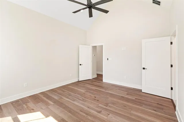 a view of a room with wooden floor and white walls