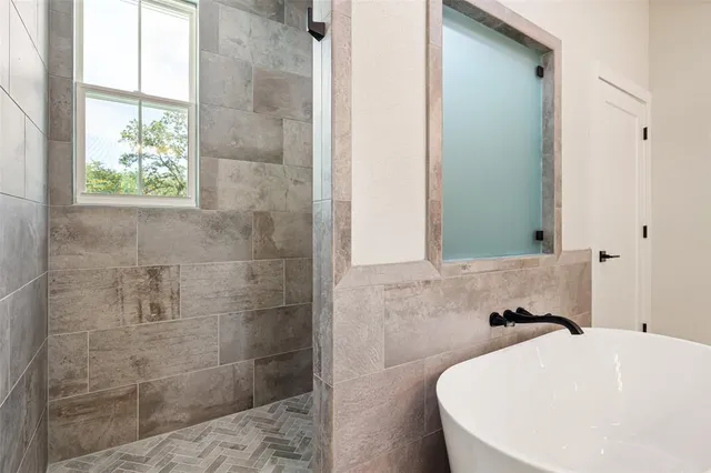 a bathroom with a bathtub and a shower