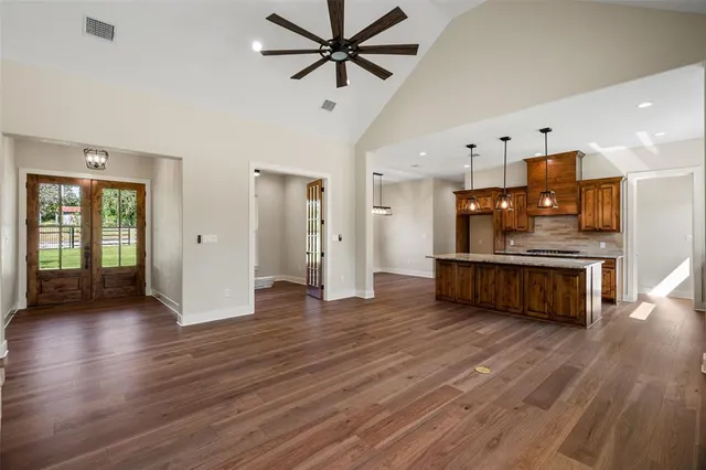 a view of a kitchen with furniture and wooden floor