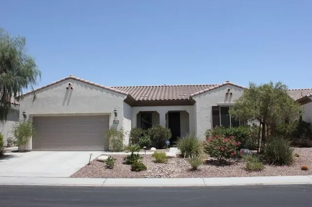 a front view of a house with porch and garden
