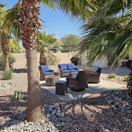 a view of a backyard with sitting area