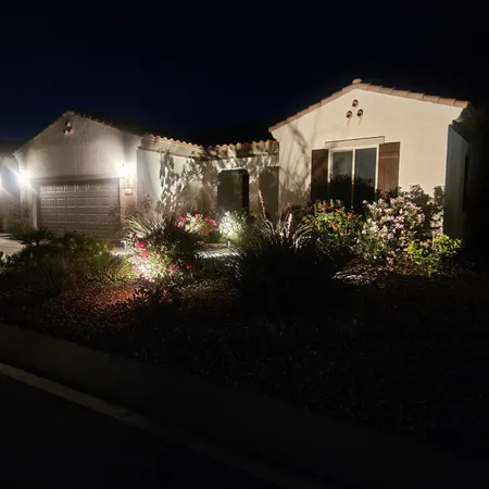 a front view of a house with a garden