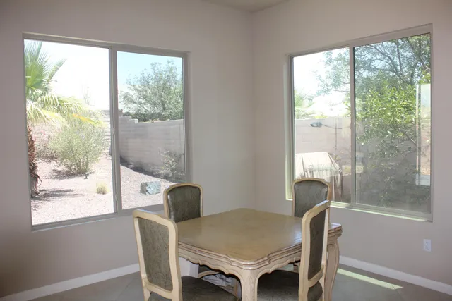 a view of a dining room with furniture and a window