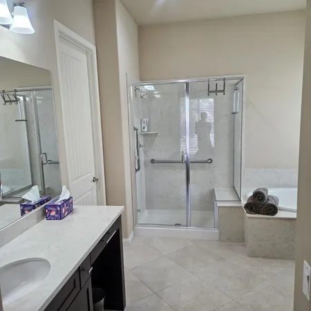 a spacious bedroom with a bed and a flat screen tv