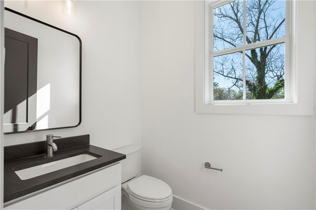 1901 Browns Mill Road Southeast Atlanta, GA 30315 - Photo 19 of 42 a bathroom with a toilet sink and mirror
