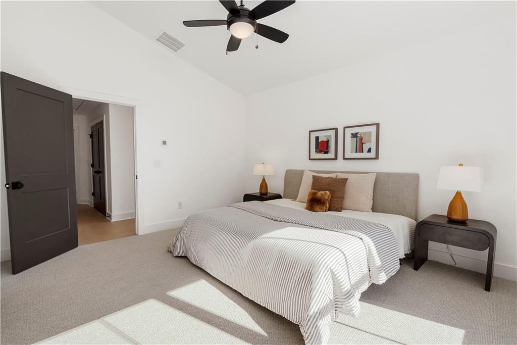 1901 Browns Mill Road Southeast Atlanta, GA 30315 - Photo 22 of 42 a bedroom with a bed and a chandelier